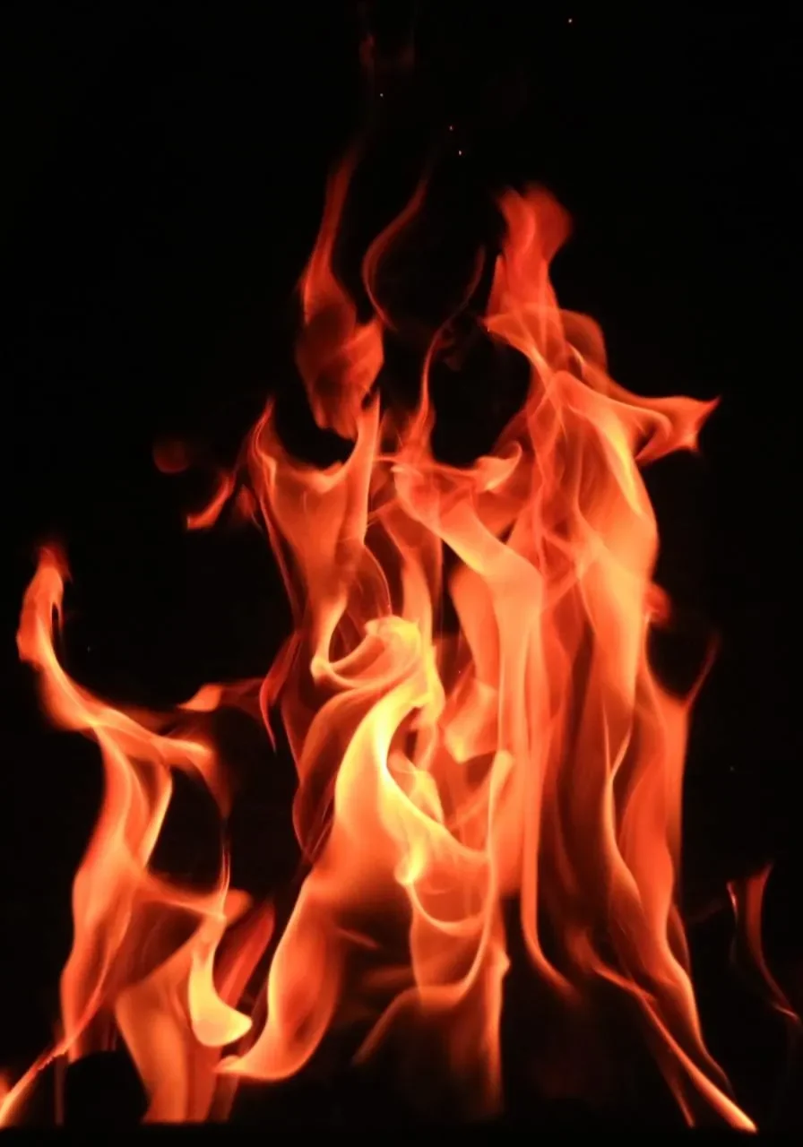 Bright orange flames dancing against a black background.